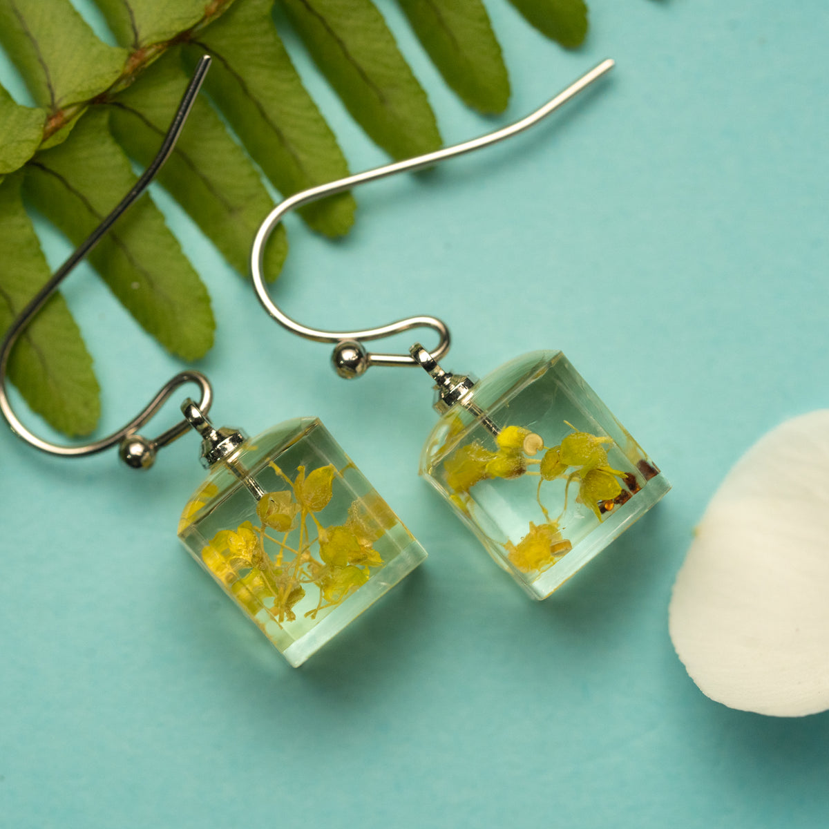 Sunlit Bloom: A Yellow Flower’s Warmth in a Light Box Earring